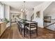 Elegant dining area featuring hardwood floors, stylish lighting, and seamless access to the kitchen and staircase at 411 Old Town Village Rd, Waxhaw, NC 28173