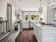Bright kitchen featuring stainless steel appliances, white cabinetry, a center island, and natural light from large windows at 411 Old Town Village Rd, Waxhaw, NC 28173