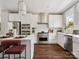 Modern kitchen featuring stainless steel appliances, white cabinetry, and a central island with barstool seating at 411 Old Town Village Rd, Waxhaw, NC 28173