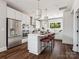 Modern kitchen with stainless steel appliances, a central island with seating, and ample counter space at 411 Old Town Village Rd, Waxhaw, NC 28173