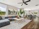 Open-concept living room flows into dining area with natural light and modern decor at 411 Old Town Village Rd, Waxhaw, NC 28173