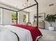 Bright main bedroom with a four poster bed, large windows, and views of the surrounding trees at 411 Old Town Village Rd, Waxhaw, NC 28173