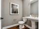 Elegant powder room boasts a pedestal sink, decorative mirror, and stylish wallpaper at 411 Old Town Village Rd, Waxhaw, NC 28173