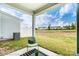 Covered back patio with a comfortable chair and view of the expansive lawn area at 4248 Black Ct # 232, Harrisburg, NC 28075