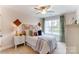 Comfortable bedroom with neutral carpet, a ceiling fan, natural light, and a bamboo headboard at 4248 Black Ct # 232, Harrisburg, NC 28075