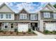 Charming townhome with a stone and siding exterior, front-entry garage, and well-maintained landscaping at 4248 Black Ct # 232, Harrisburg, NC 28075