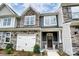 Beautiful townhome exterior features stone accents, a front-entry garage, and a welcoming front porch at 4248 Black Ct # 232, Harrisburg, NC 28075