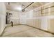 Unfinished garage area with concrete floor, water heater, and door to outside at 4248 Black Ct # 232, Harrisburg, NC 28075