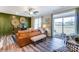 Open-concept living room with stylish furnishings, a textured accent wall, and access to the outdoor patio at 4248 Black Ct # 232, Harrisburg, NC 28075