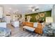 Living room showcasing a modern kitchen, dining area, comfortable seating, and a decorative accent wall at 4248 Black Ct # 232, Harrisburg, NC 28075