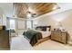 Luxurious main bedroom with a wood tray ceiling, ceiling fan, and lots of natural light from the windows at 4248 Black Ct # 232, Harrisburg, NC 28075