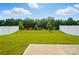 The spacious backyard has a white fence, large grassy area, and a patio at 4439 Wild Ridge Dr, Charlotte, NC 28215