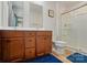 Bathroom with a double sink vanity, wood cabinets, large mirror, and glass-enclosed shower at 4439 Wild Ridge Dr, Charlotte, NC 28215
