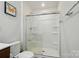 Well-lit bathroom featuring a sleek glass-enclosed shower and modern fixtures at 4439 Wild Ridge Dr, Charlotte, NC 28215