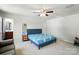 Spacious bedroom with carpet, ceiling fan, and a door leading to the en-suite bathroom at 4439 Wild Ridge Dr, Charlotte, NC 28215