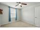Neutral-colored bedroom has a ceiling fan, natural light from window, and access to a closet at 4439 Wild Ridge Dr, Charlotte, NC 28215