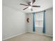 An empty bedroom features a ceiling fan, natural light from a window, and neutral carpet at 4439 Wild Ridge Dr, Charlotte, NC 28215