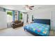 The carpeted bedroom offers a sofa, ceiling fan, natural light, and outdoor views at 4439 Wild Ridge Dr, Charlotte, NC 28215