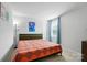Bedroom with orange bedspread, window with curtains, and wall art at 4439 Wild Ridge Dr, Charlotte, NC 28215