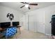 This bedroom features neutral walls, a ceiling fan, and is currently being used as a gaming room at 4439 Wild Ridge Dr, Charlotte, NC 28215