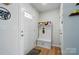 Bright entryway featuring a hall tree with bench seating, coat hooks, and storage at 4439 Wild Ridge Dr, Charlotte, NC 28215