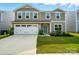Two-story home featuring neutral siding, a two-car garage, and a well-manicured lawn at 4439 Wild Ridge Dr, Charlotte, NC 28215