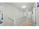Upstairs hallway with neutral paint, plush carpet, and easy access to multiple rooms at 4439 Wild Ridge Dr, Charlotte, NC 28215