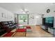 Cozy living room featuring wood floors, a ceiling fan, and a large window at 4439 Wild Ridge Dr, Charlotte, NC 28215