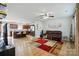 Open-concept living room featuring wood floors, modern furniture, and stainless steel appliances at 4439 Wild Ridge Dr, Charlotte, NC 28215
