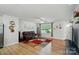 Sunlit living room boasting wood floors, stylish decor, and comfortable seating at 4439 Wild Ridge Dr, Charlotte, NC 28215