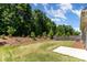 Spacious backyard with lush green grass and mature trees offering a private outdoor space at 5053 Arbordale Way, Mount Holly, NC 28120