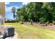 Spacious backyard with lush green grass and mature trees offering a private outdoor space at 5053 Arbordale Way, Mount Holly, NC 28120