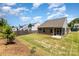 Aerial view of a large backyard featuring a patio, lush lawn, and privacy fence at 5053 Arbordale Way, Mount Holly, NC 28120
