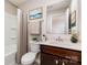 Bright bathroom featuring a shower-tub combination, framed mirror, and sleek vanity with marble countertop at 5053 Arbordale Way, Mount Holly, NC 28120