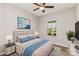 Comfortable staged bedroom with blue accents, side tables and a view to the outdoors at 5053 Arbordale Way, Mount Holly, NC 28120