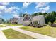Charming home with well-maintained lawn, inviting entryway, and attached two car garage at 5053 Arbordale Way, Mount Holly, NC 28120