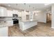 Bright kitchen featuring granite countertops, stainless steel appliances, and island seating at 5053 Arbordale Way, Mount Holly, NC 28120