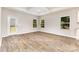 Living room featuring wood floors, a back door to the yard, and bright windows at 5053 Arbordale Way, Mount Holly, NC 28120