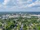 Aerial view of buildings and a city skyline in the distance, surrounded by lush greenery and trees at 5522 Sharon Rd, Charlotte, NC 28210