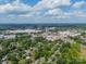 Aerial view featuring buildings, tree-lined streets, and open sky at 5522 Sharon Rd, Charlotte, NC 28210
