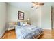 Cozy bedroom with hardwood floors, a ceiling fan, and a comfortable bed, providing a serene retreat at 5522 Sharon Rd, Charlotte, NC 28210