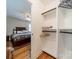 Walk-in closet with built-in shelving and hanging rods for optimal storage space, adjacent to the bedroom at 5522 Sharon Rd, Charlotte, NC 28210