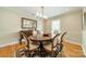 Elegant dining room with hardwood floors, large oval table, classic chairs, and modern lighting at 5522 Sharon Rd, Charlotte, NC 28210