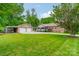 Charming brick home featuring a lush green lawn, two car garage, and well manicured trees at 5522 Sharon Rd, Charlotte, NC 28210