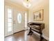 Classic foyer with tiled floors, decorative front door, and charming wood desk with decorative painting at 5522 Sharon Rd, Charlotte, NC 28210