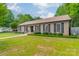 Well-maintained brick home with lush lawn, charming shutters, and an inviting entrance at 5522 Sharon Rd, Charlotte, NC 28210