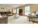 Bright living room featuring hardwood floors, large windows, crown molding, and neutral tones at 5522 Sharon Rd, Charlotte, NC 28210