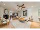 Open living room with white brick fireplace, ceiling fan, and tile floors at 5522 Sharon Rd, Charlotte, NC 28210