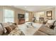 Spacious living room featuring hardwood floors, large windows, crown molding, and neutral tones at 5522 Sharon Rd, Charlotte, NC 28210