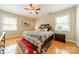 Comfortable main bedroom with hardwood floors, ceiling fan, and a decorative rug adding warmth to the space at 5522 Sharon Rd, Charlotte, NC 28210
